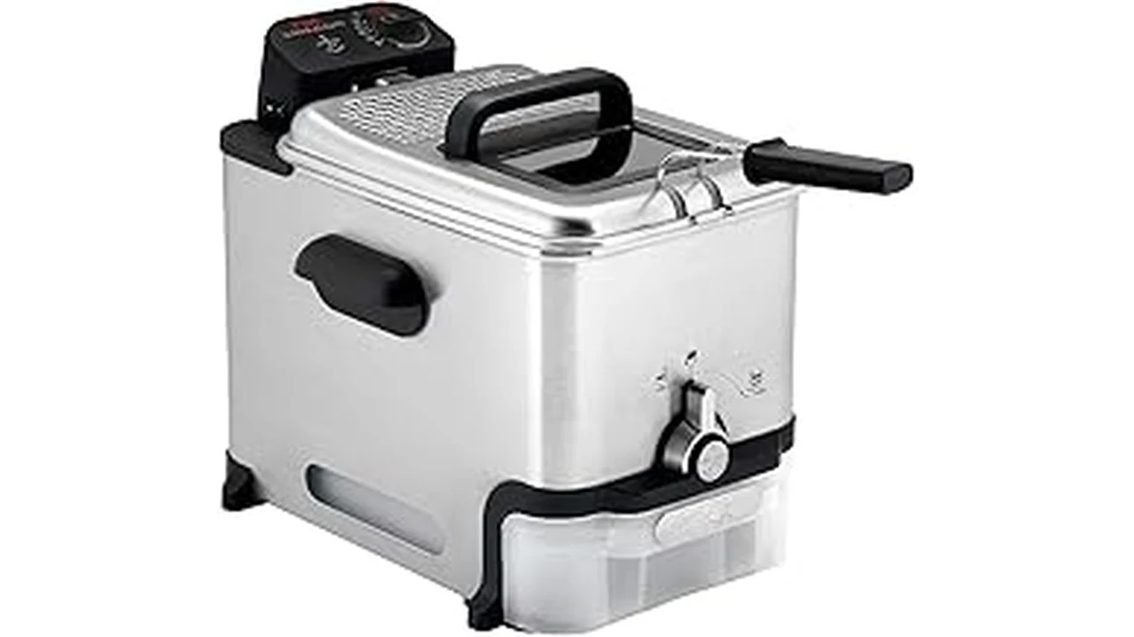 This image shows a shiny, modern deep fryer with crispy fried chicken pieces inside.